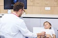 Doctor testing young boy with usg