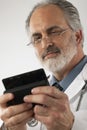 Doctor Texting on a Cell Phone Royalty Free Stock Photo