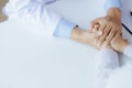 Doctor touches the arm to encourage the patient in the hospital examination room, treating the disease from a medical professional