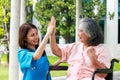 The doctor touches the hand of an elderly female patient