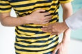 Doctor touches the patient`s stomach. who are having a stomachache pain.