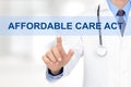 Doctor touching AFFORDABLE CARE ACT tab on virtual screen Royalty Free Stock Photo