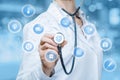 A doctor is touching a digital scheme of wireless connections containing small spheres with medical icons inside.The concept is