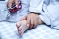 Doctor touching foot of Asian senior or elderly old lady woman patient with love, care, helping, encourage and empathy at nursing Royalty Free Stock Photo