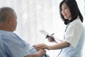 Doctor touching hands to encouragement mental of elderly patient after surgery at bed in hospital Royalty Free Stock Photo