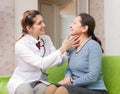 Doctor touching neck of patient Royalty Free Stock Photo