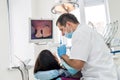 Doctor treating female patients teeth in dentistry