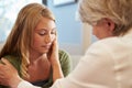 Doctor Treating Teenage Girl Suffering With Depression Royalty Free Stock Photo