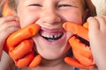 The doctor is trying to see the mouth of a little girl with an orthodontic appliance and crooked teeth Royalty Free Stock Photo