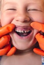 The doctor is trying to see the mouth of a little girl with an orthodontic appliance and crooked teeth Royalty Free Stock Photo