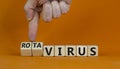 Doctor turns cubes and changes the word 'virus' to 'rotavirus'. Beautiful orange background. Medica