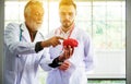 Doctor man working and using skull with plastic brain model together at laboratory Royalty Free Stock Photo