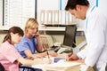 Doctor With Two Nurses Working At Nurses Station Royalty Free Stock Photo