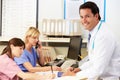 Doctor With Two Nurses Working At Nurses Station Royalty Free Stock Photo