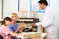 Doctor With Two Nurses Working At Nurses Station Royalty Free Stock Photo