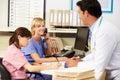 Doctor With Two Nurses Working At Nurses Station Royalty Free Stock Photo