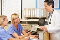 Doctor With Two Nurses Working At Nurses Station Royalty Free Stock Photo