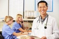 Doctor With Two Nurses Working At Nurses Station Royalty Free Stock Photo