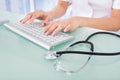Doctor Typing On Computer Keyboard In Clinic Royalty Free Stock Photo