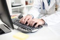 Doctor typing on a computer keyboard Royalty Free Stock Photo