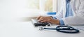 doctor typing on computer keyboard. working in hospital office. online medical consultation, communication and ehealth concept. Royalty Free Stock Photo