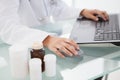 Doctor typing out prescriptions Royalty Free Stock Photo