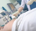 Doctor ultrasonographer examines patient in the hospital