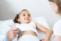 Doctor ultrasound examines little girl belly