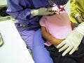 Doctor in uniform checking up Dentist examining kid`s teeth at dental clinic