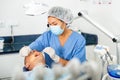 Doctor in uniform is examinating man on chair in hospital