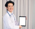 Doctor in uniform and stethoscope neck strap showing front blank screen smart digital tablet on hand