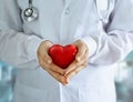 Doctor with stethoscope and red heart shape in hands on hospital Royalty Free Stock Photo