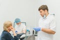 Doctor used microscope. Dentist is treating patient in modern dental office. Operation is carried out using cofferdam Royalty Free Stock Photo