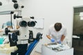 Doctor used microscope. Dentist is treating patient in modern dental office. Operation is carried out using cofferdam Royalty Free Stock Photo