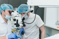 Doctor used microscope. Dentist is treating patient in modern dental office. Operation is carried out using cofferdam Royalty Free Stock Photo