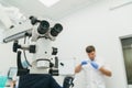 Doctor used microscope. Dentist is treating patient in modern dental office. Operation is carried out using cofferdam Royalty Free Stock Photo