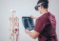 Doctor uses augmented reality goggles to exam x-rays film