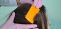 Doctor uses lice comb for little girl hair