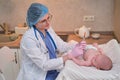 The doctor uses a syringe to inject a newborn child. A nurse in uniform is preparing to vaccinate a child Royalty Free Stock Photo