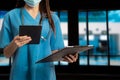 Doctor using clipboard and digital tablet find information patient medical history at the hospital. Medical technology concept Royalty Free Stock Photo