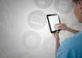 Doctor using digital tablet against digitally generated icons Royalty Free Stock Photo