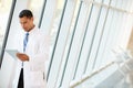 Doctor Using Digital Tablet In Corridor Of Modern Hospital Royalty Free Stock Photo