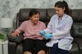 doctor using glucometer checking blood sugar level of senior woman. diabetes concept