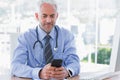 Doctor using his smartphone Royalty Free Stock Photo