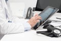 Doctor using his tablet computer at work Royalty Free Stock Photo