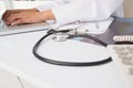 Doctor using laptop near stethoscope and clipboard Royalty Free Stock Photo