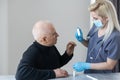 Doctor using nose swab test coronavirus COVID-19 with senior elderly male in hospital. Medical examination for COVID-19 Royalty Free Stock Photo