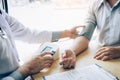 Doctor is using a pulse meter to measure the pressure of the patient at the hospital Royalty Free Stock Photo