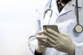 Doctor using smartphone with patient in hospital interior blur for background, Search.