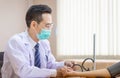 Doctor using sphygmomanometer checking blood pressure to a patient, doctor checking blood pressure Royalty Free Stock Photo